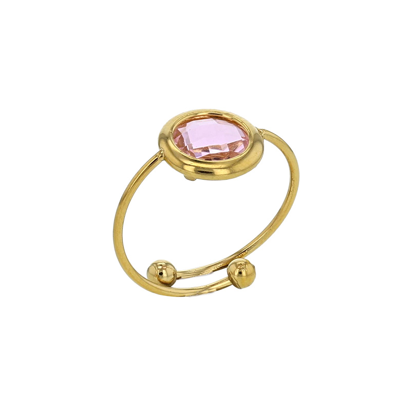 Bague réglable ornée d'un rond en verre facetté bleu marine, acier doré
