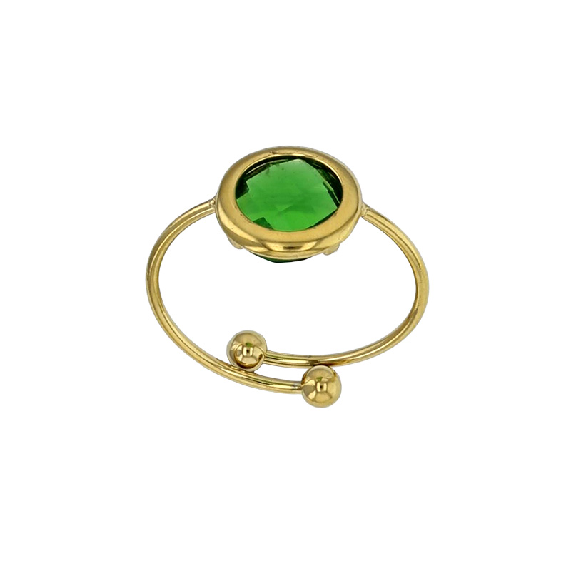 Bague réglable ornée d'un rond en verre facetté bleu marine, acier doré