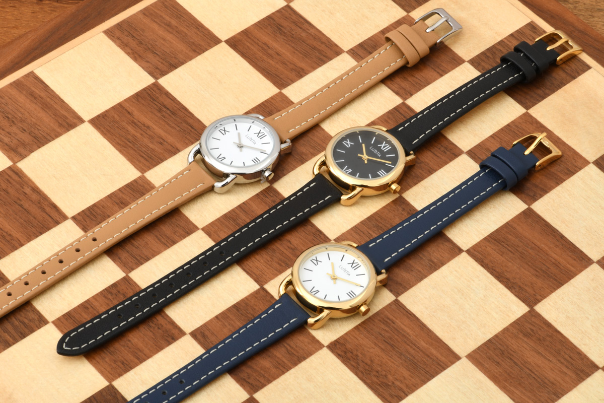 Montre Lutetia boîtier métal doré, cadran blanc, bracelet cuir de bovin marron clair, surpiqûres